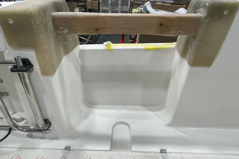 Slide: The Image of 2024 Boston Whaler 360 Outrage boat interior detail with ladder and unfinished components. - 64