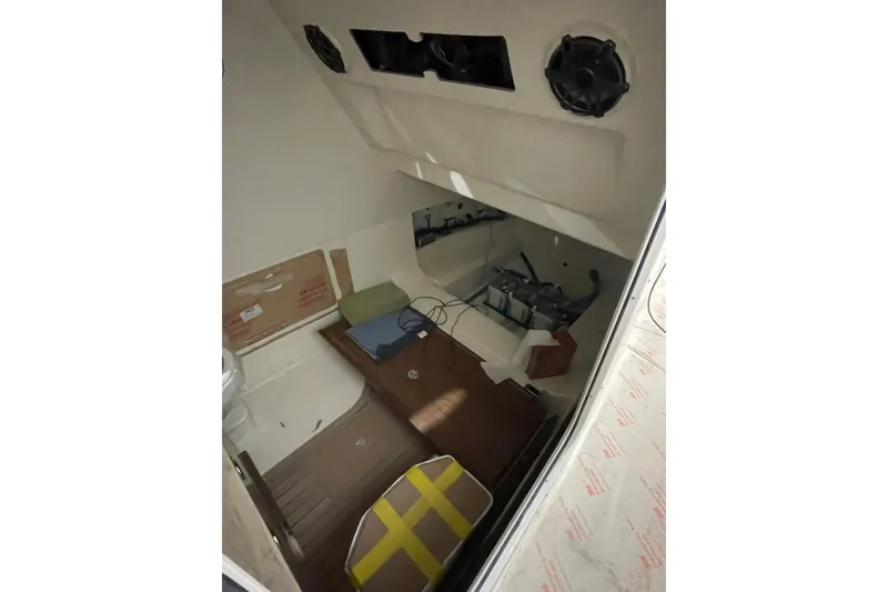 Slide: The Image of 2024 Boston Whaler 360 Outrage cabin interior with wooden flooring and storage space. - 70