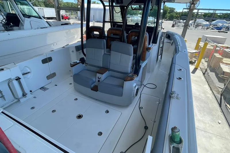 Slide: The Image of 2024 Boston Whaler 360 Outrage boat interior with seating and deck view. - 73