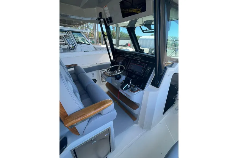 Slide: The Image of 2024 Boston Whaler 360 Outrage helm with advanced navigation systems and comfortable seating. - 74