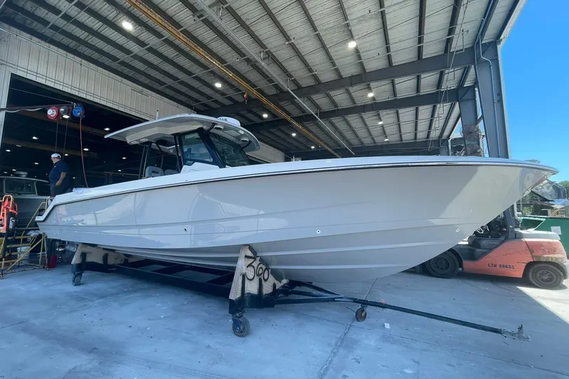 Slide: The Image of 2024 Boston Whaler 360 Outrage boat in a warehouse setting. - 77