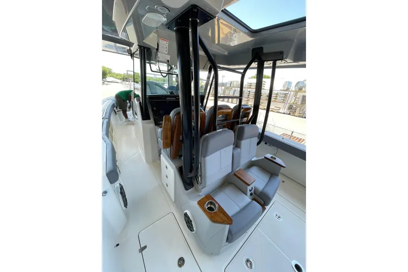 Slide: The Image of 2024 Boston Whaler 360 Outrage interior with seating and helm, showcasing modern design. - 78