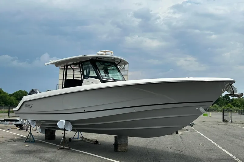 Slide: The Image of 2024 Boston Whaler 360 Outrage boat on display under cloudy sky. - 86