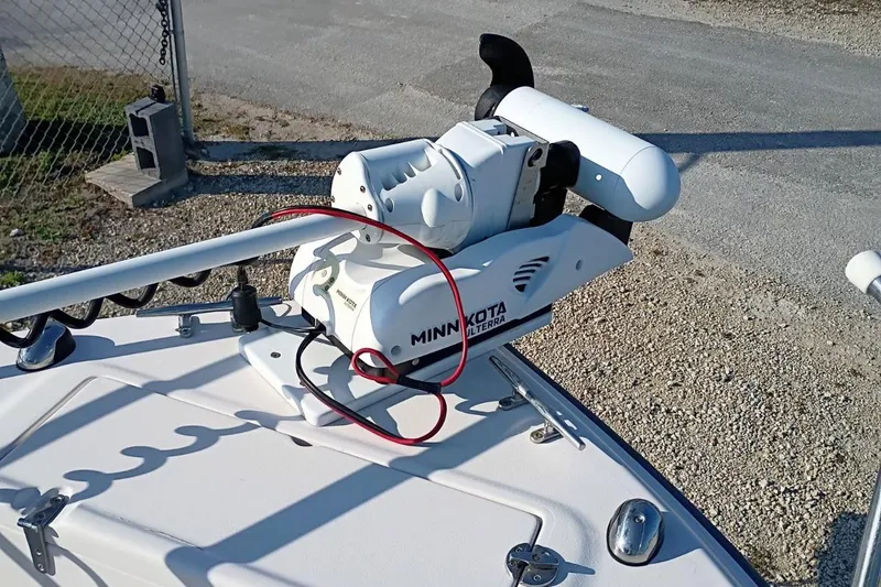 Slide: The Image of Minn Kota Ulterra motor on 2004 Grady-White Escape 209 boat, parked on gravel. - 10