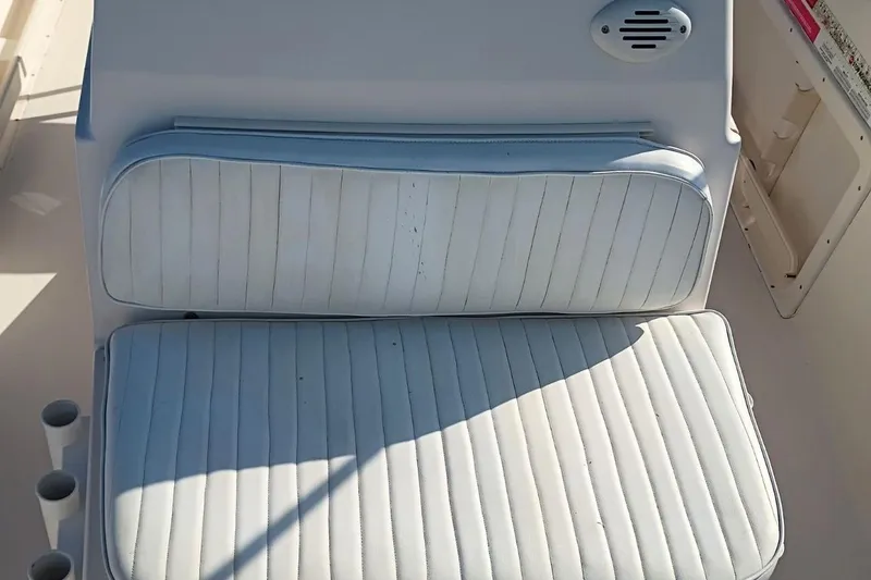 Slide: The Image of 2004 Grady-White Escape 209 boat seat with white cushioned upholstery. - 14