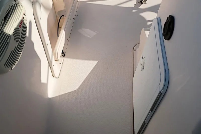 Slide: The Image of 2004 Grady-White Escape 209 boat interior with speaker and storage compartment. - 16