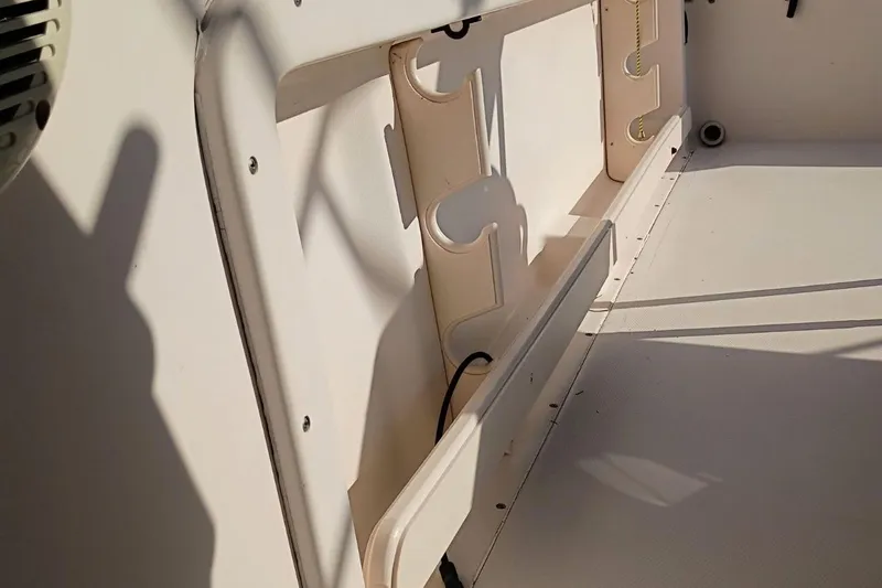 Slide: The Image of Interior view of a 2004 Grady-White Escape 209 boat, showing storage compartments. - 17
