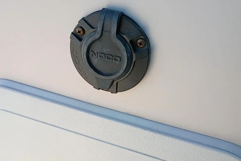 Slide: The Image of NOCO plug on 2004 Grady-White Escape 209 boat exterior. - 18