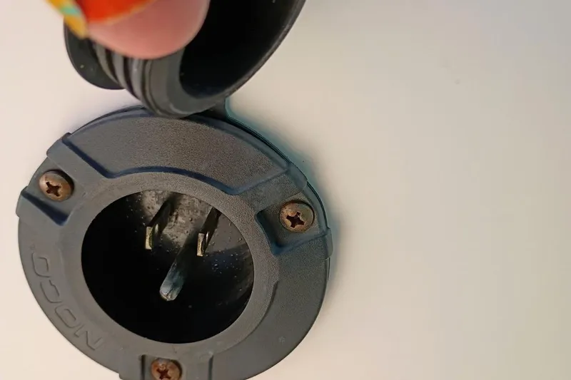 Slide: The Image of 2004 Grady-White Escape 209 boat power socket with protective cap. - 20