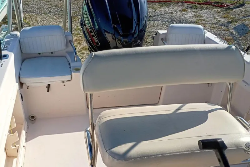 Slide: The Image of 2004 Grady-White Escape 209 boat interior with seating and outboard motor. - 21