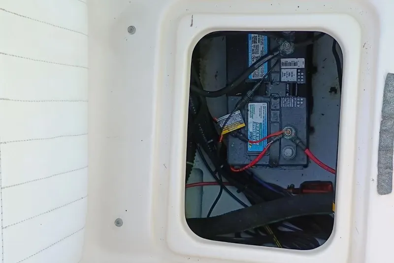 Slide: The Image of Battery compartment of 2004 Grady-White Escape 209 boat, showing marine batteries and wiring. - 22