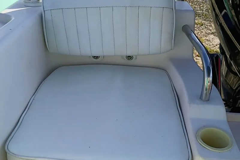 Slide: The Image of White cushioned seat on 2004 Grady-White Escape 209 boat with cup holder. - 23