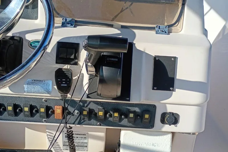 Slide: The Image of 2004 Grady-White Escape 209 boat dashboard with Yamaha controls and various switches. - 3