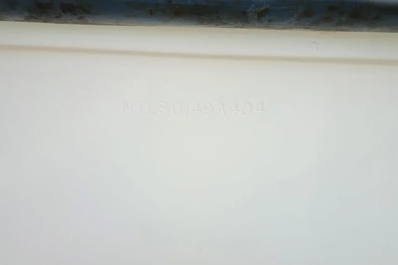 Slide: The Image of 2004 Grady-White Escape 209 hull identification number on white surface. - 32