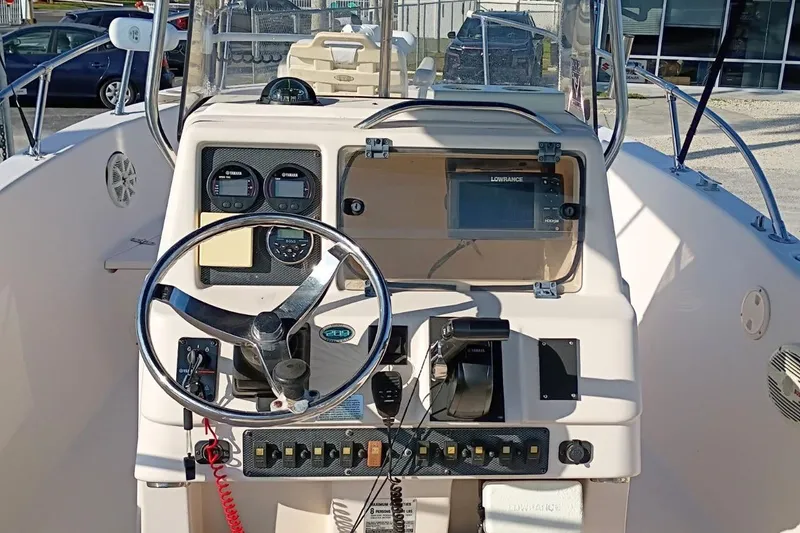Slide: The Image of 2004 Grady-White Escape 209 boat dashboard with steering wheel and navigation equipment. - 33