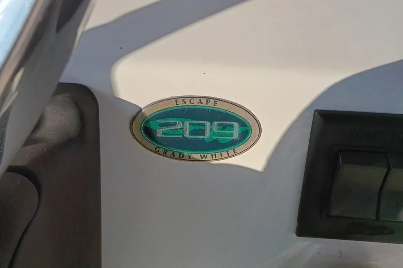 Slide: The Image of 2004 Grady-White Escape 209 boat emblem with control panel. - 5