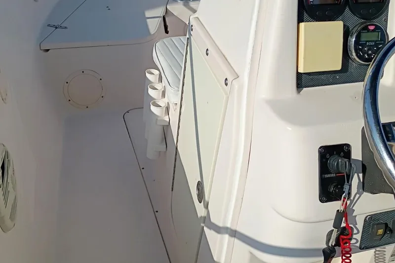 Slide: The Image of 2004 Grady-White Escape 209 boat interior with steering wheel and control panel. - 7