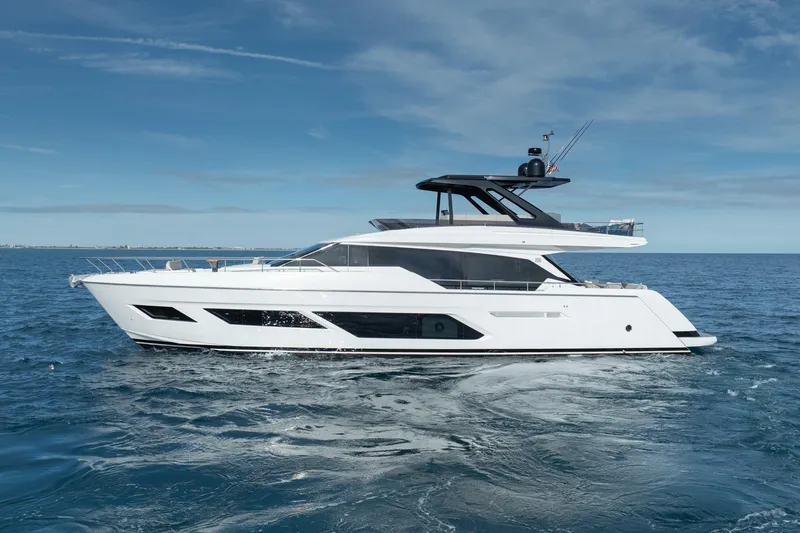 Slide: The Image of 2023 Ferretti Yachts 720 cruising on open sea under clear blue sky. - 14