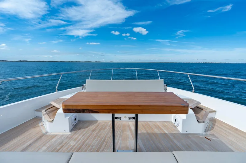 Slide: The Image of Luxurious 2023 Ferretti Yachts 720 deck with ocean view and wooden table. - 30