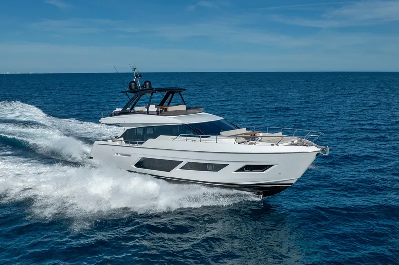 Slide: The Image of Luxury 2023 Ferretti Yachts 720 cruising on open sea under clear blue sky. - 5