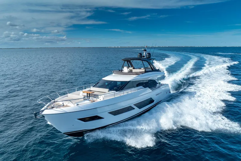 Slide: The Image of 2023 Ferretti Yachts 720 cruising on open sea under clear blue sky. - 6