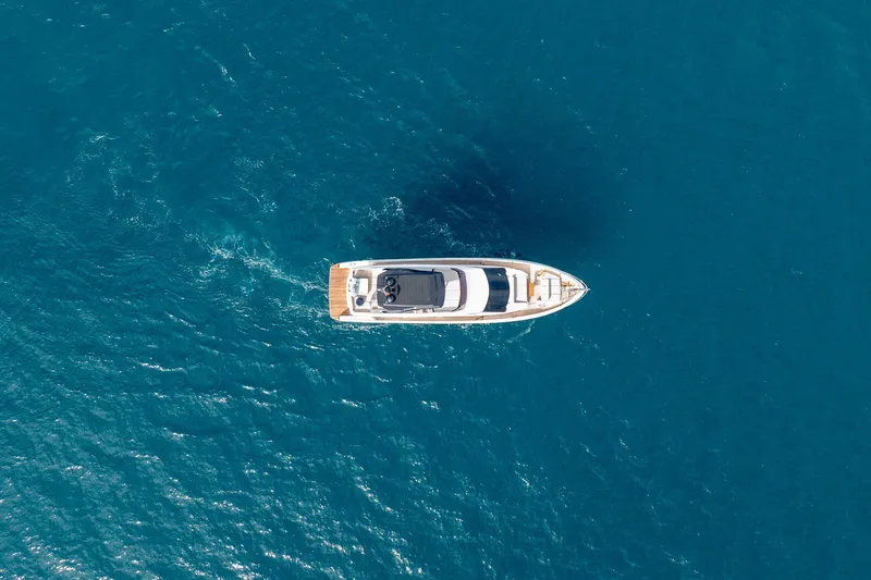 Slide: The Image of Aerial view of 2023 Ferretti Yachts 720 cruising on blue ocean waters. - 7