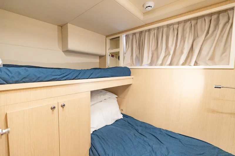 Slide: The Image of Interior cabin of 2023 Ferretti Yachts 720 with bunk beds and wooden finish. - 74