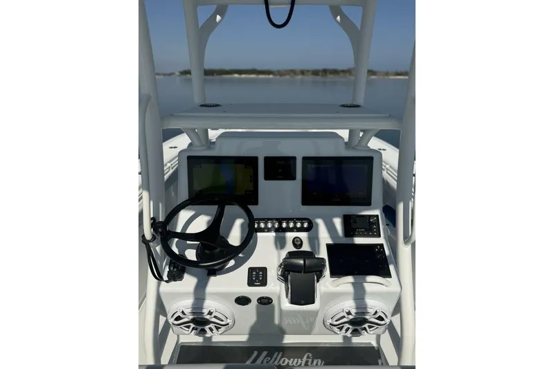 Slide: The Image of 2025 Yellowfin 26 Hybrid boat dashboard with steering wheel and electronic displays. - 11