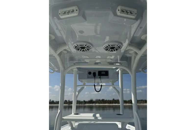 Slide: The Image of 2025 Yellowfin 26 Hybrid boat interior with speakers and electronics, showcasing modern design. - 14