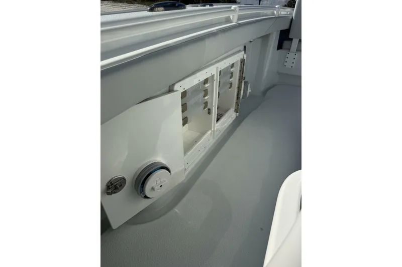 Slide: The Image of 2025 Yellowfin 26 Hybrid boat interior with storage compartment and control panel. - 19