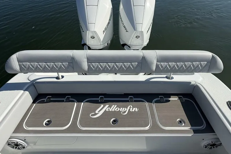 Slide: The Image of 2025 Yellowfin 26 Hybrid boat with dual Mercury engines on calm water. - 23