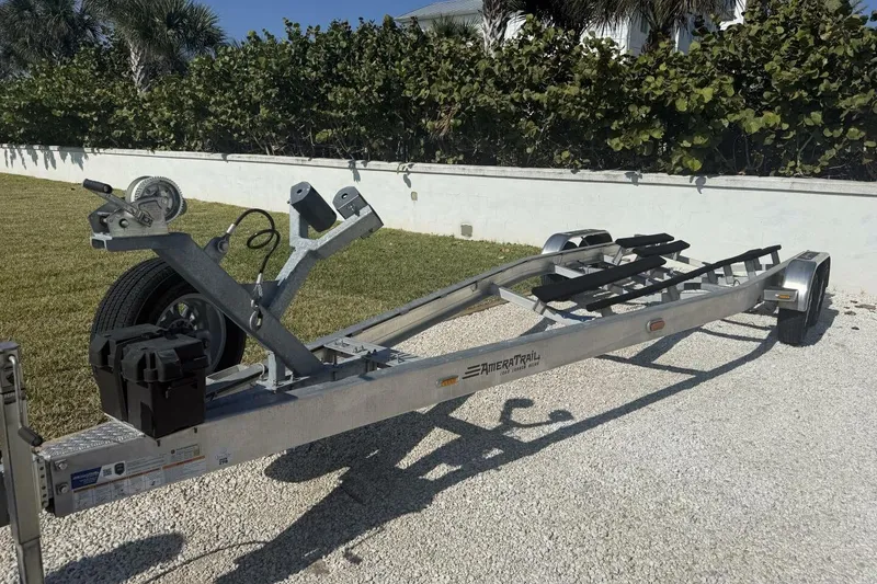 Slide: The Image of Trailer for 2025 Yellowfin 26 Hybrid boat, parked on gravel driveway. - 30
