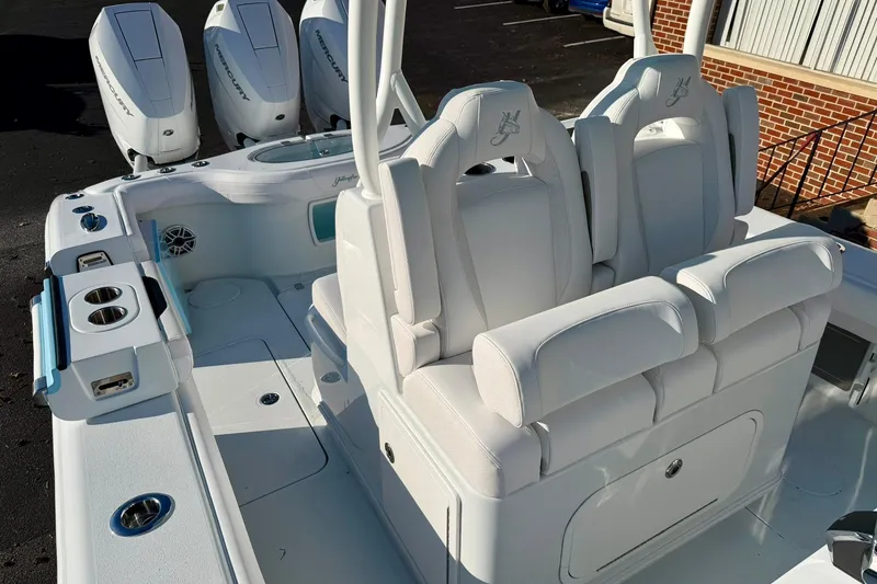 Slide: The Image of 2026 Yellowfin 36 Offshore boat interior with triple Mercury engines, featuring white seating and deck. - 4