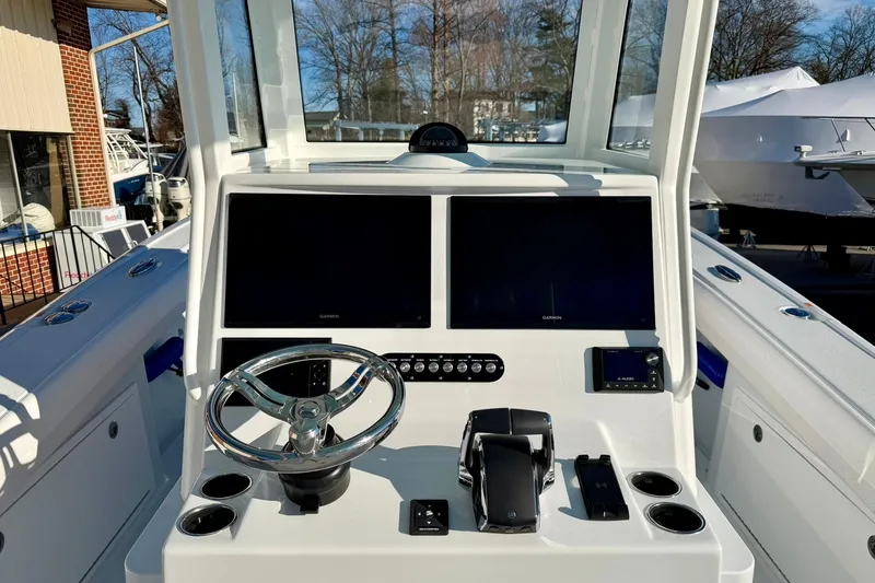 Slide: The Image of 2026 Yellowfin 36 Offshore boat dashboard with dual screens and steering wheel. - 5