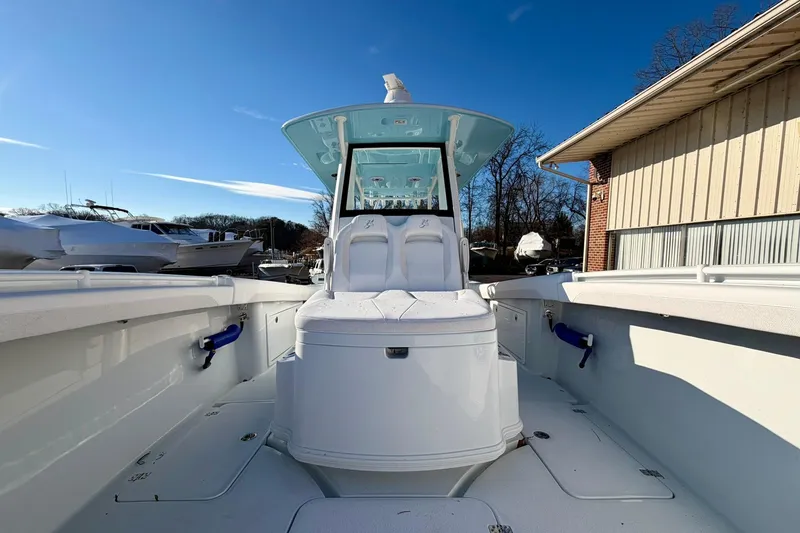 Slide: The Image of 2026 Yellowfin 36 Offshore boat, white interior, clear blue sky background. - 9
