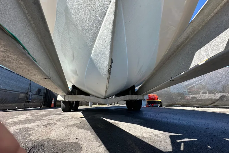 Slide: The Image of 1999 Robalo 2420 Center Console boat on trailer, viewed from below. - 12
