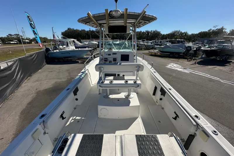 Slide: The Image of 1999 Robalo 2420 Center Console boat, spacious deck, parked outdoors under clear sky. - 13