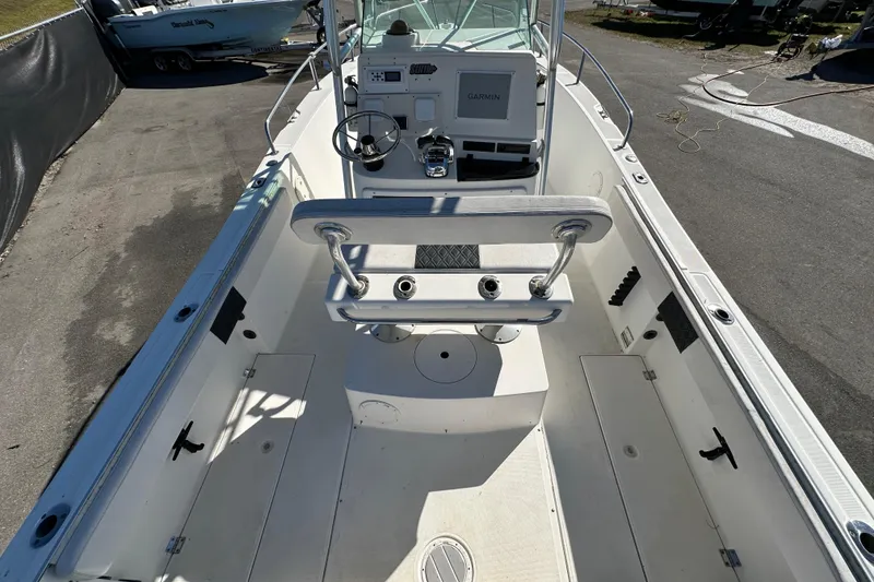 Slide: The Image of 1999 Robalo 2420 Center Console boat interior with steering wheel and Garmin display. - 14