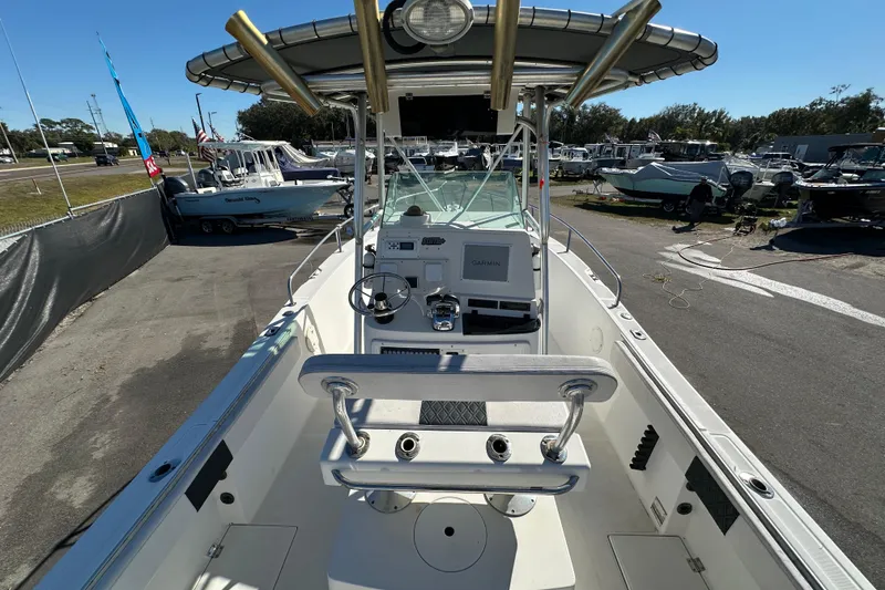 Slide: The Image of 1999 Robalo 2420 Center Console boat with steering wheel and Garmin navigation system. - 15