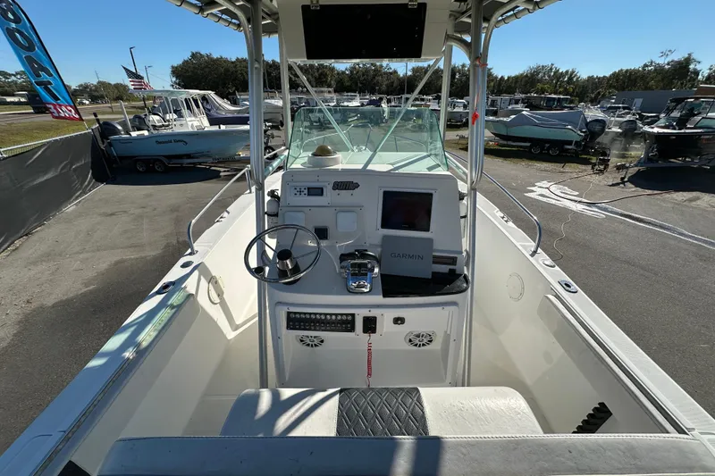 Slide: The Image of 1999 Robalo 2420 Center Console boat with Garmin navigation, parked in a marina. - 16