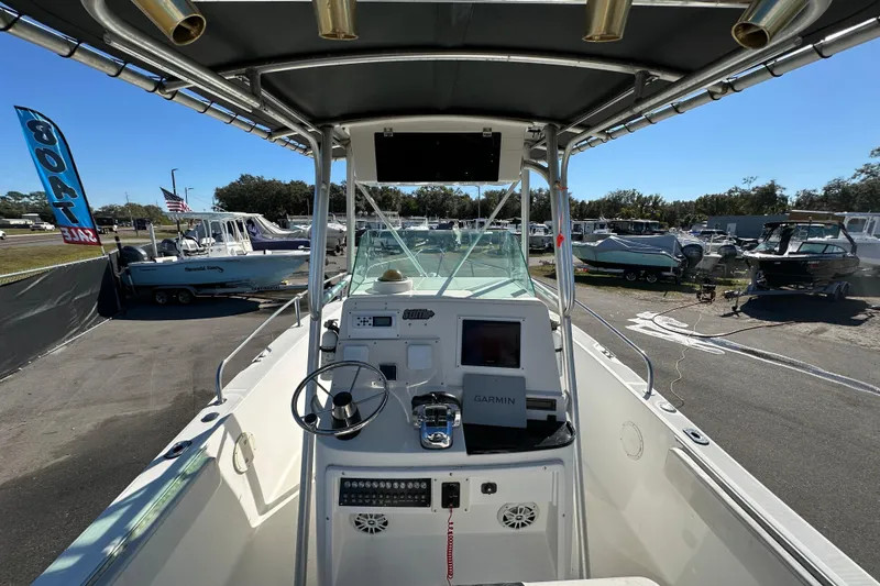 Slide: The Image of 1999 Robalo 2420 Center Console boat with Garmin navigation, displayed at a boat sale. - 18