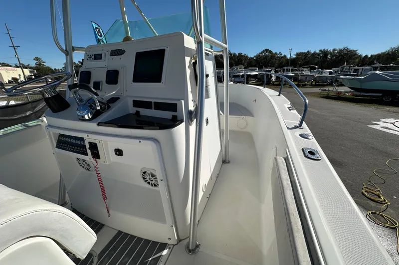 Slide: The Image of 1999 Robalo 2420 Center Console boat interior with steering wheel and control panel. - 27