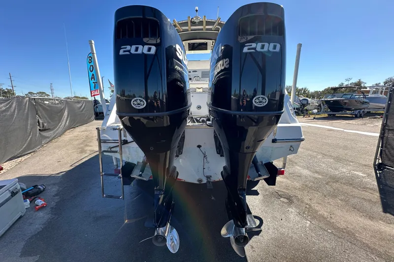 Slide: The Image of 1999 Robalo 2420 Center Console with twin Suzuki 200 engines at a boat sale. - 3