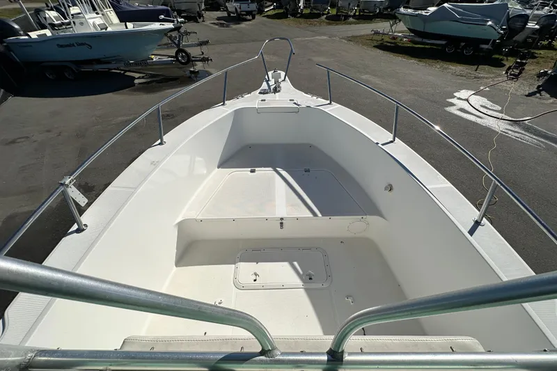 Slide: The Image of 1999 Robalo 2420 Center Console boat deck, parked in a marina. - 31