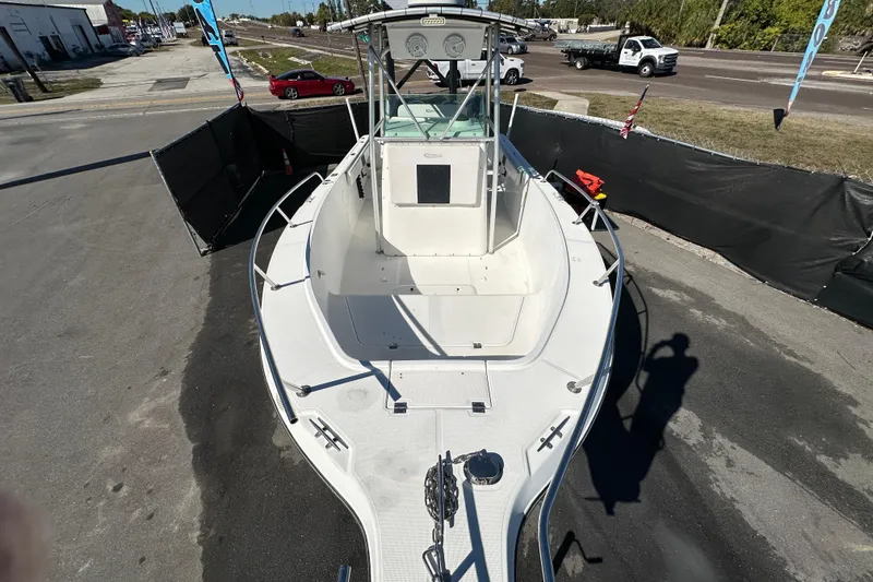 Slide: The Image of 1999 Robalo 2420 Center Console boat displayed outdoors on pavement. - 37
