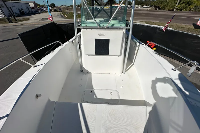 Slide: The Image of 1999 Robalo 2420 Center Console boat deck, spacious and well-maintained, with clear skies above. - 39