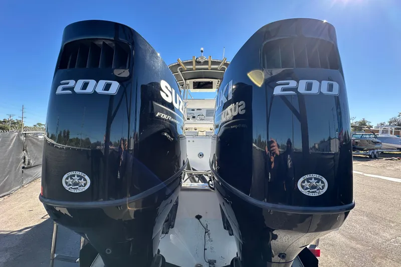 Slide: The Image of Twin Suzuki 200 outboard engines on a 1999 Robalo 2420 Center Console boat. - 4