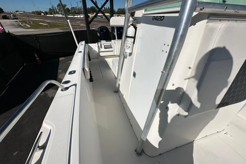 Slide: The Image of 1999 Robalo 2420 Center Console boat interior with safety equipment and shadow. - 42