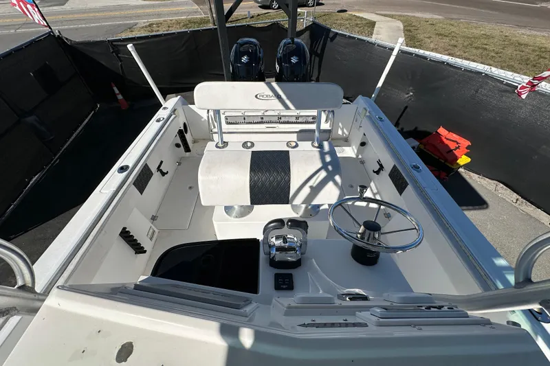 Slide: The Image of 1999 Robalo 2420 Center Console boat interior with steering wheel and seating. - 45
