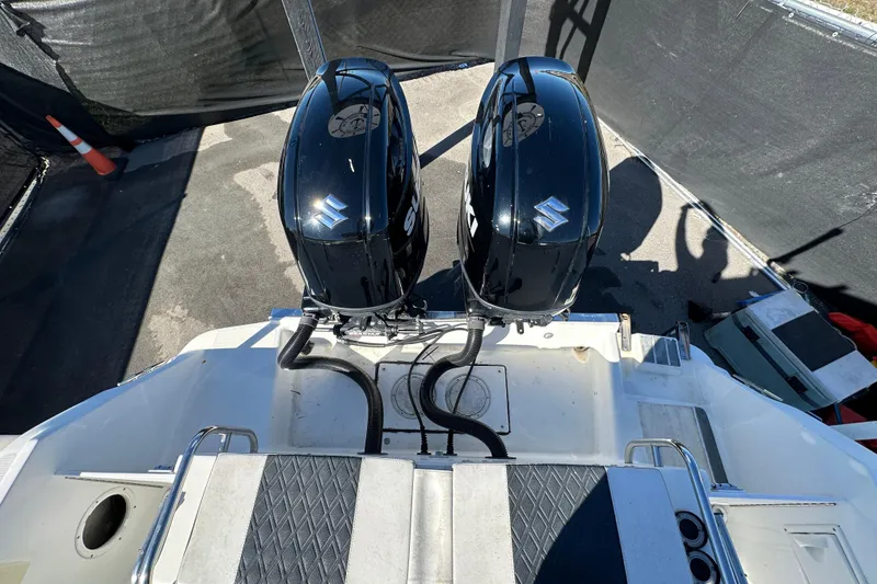 Slide: The Image of 1999 Robalo 2420 Center Console boat with dual Suzuki outboard engines. - 47